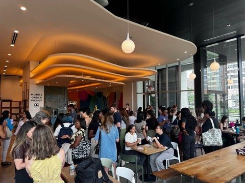 A packed cafe event full of women building in tech