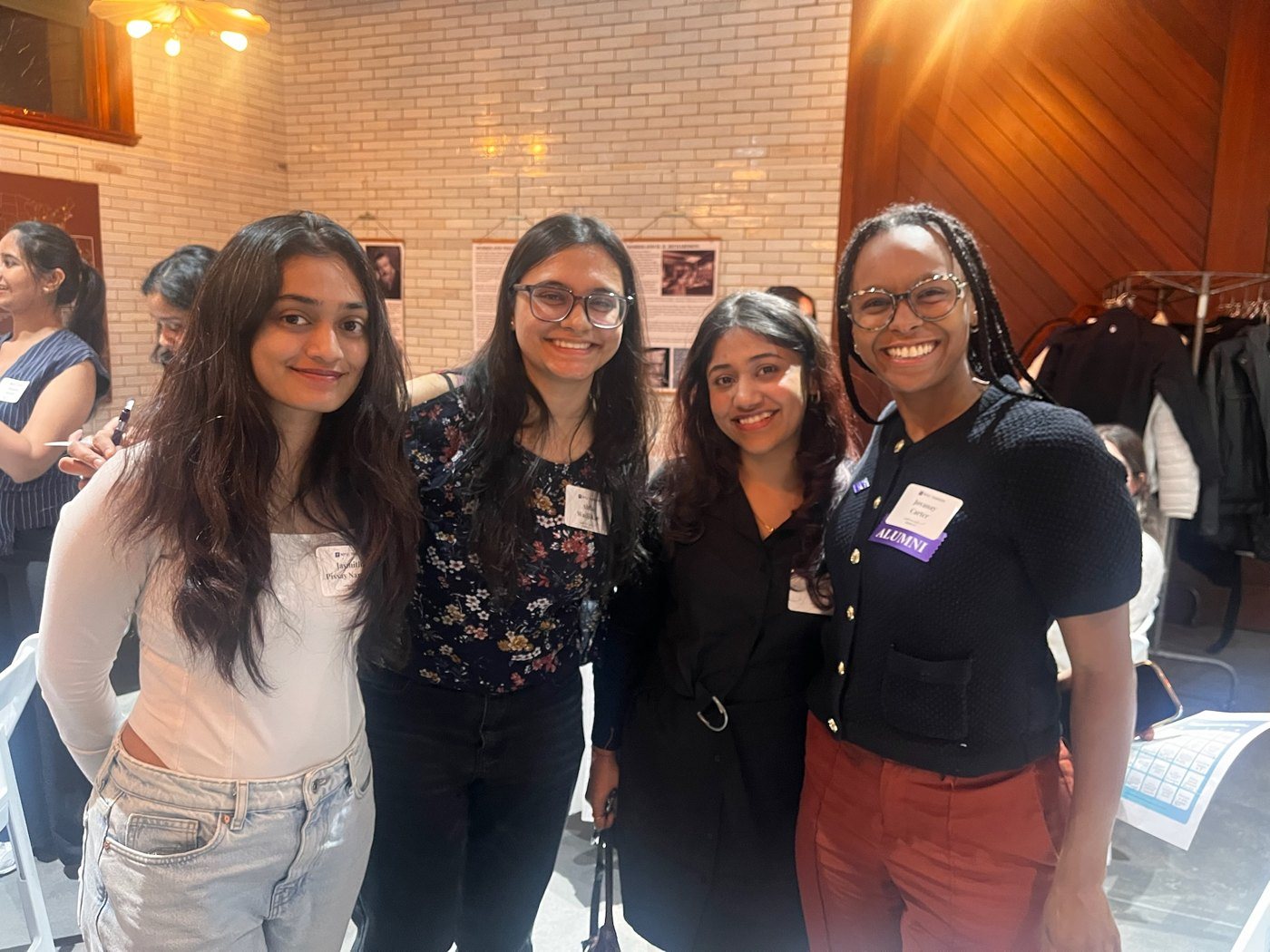 Jovanay with three students at an NYU alumni event
